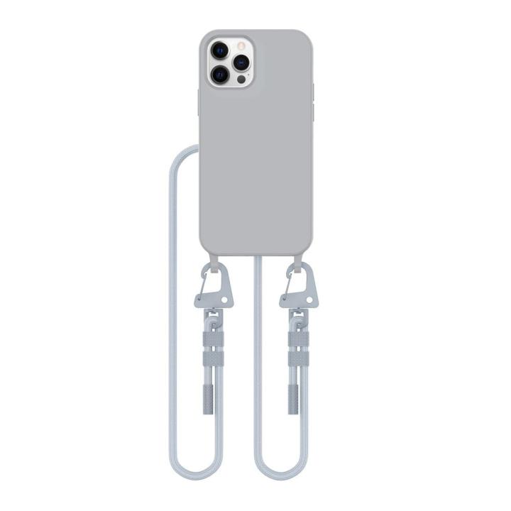 Szare etui z białym sznurkiem crossbody. Wbudowany pierścień magnetyczny MagSafe idealny do mocowania akcesoriów. Wygodny sznurek pozwala na noszenie iPhone 12 / 12 Pro, chroniąc go przed upadkami.